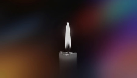 A solitary candle burns softly, casting a gentle flame amid a rich, multicolored bokeh backdrop. The image conveys calm, contemplative mood, warmth. AI Generatedの写真素材
