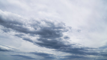 low level thick grey and puffy clouds a dramatic stormy sky with a approaching weather systemの写真素材