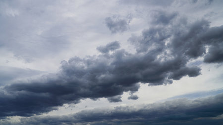 A dramatic, overcast sky filled with heavy dark clouds . ideal for weather, nature, or dramatic ambiance projects.の写真素材