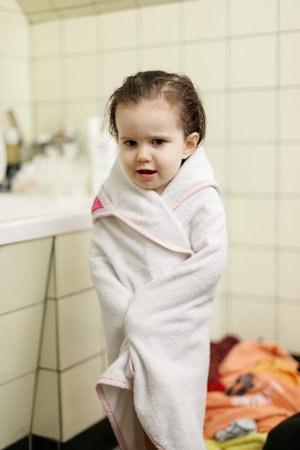 Little girl after bath wrapped in white towelの写真素材