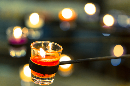 Focused Red candle in a glass with round stick standの写真素材