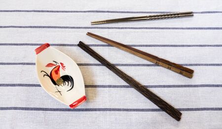 Three Chopsticks and Traditional Thai Chicken Bowl on White Tableの写真素材