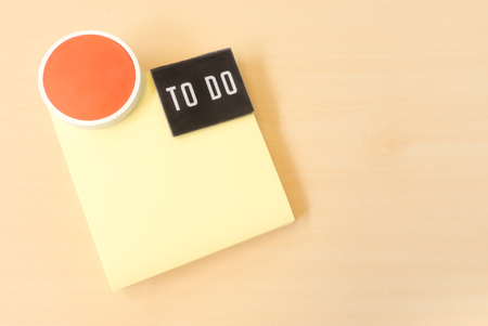 To Do List on Yellow Sticky Paper Note on Brown Backgroundの写真素材