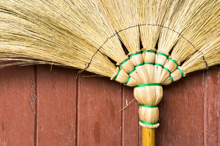 Broom Stick Lay on a Brown Wooden Doorの写真素材