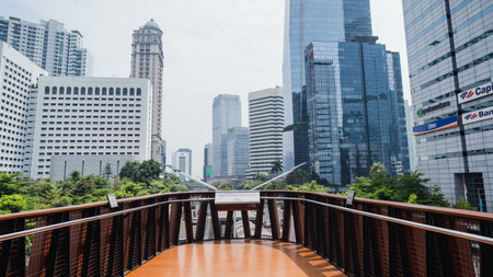"Jakarta, Indonesia - October 2022: the bridge on the pedestrian bridge that is shaped like a phinisi ship with a beautiful background of tall buildings."のeditorial素材