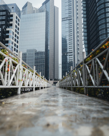 "Jakarta, Indonesia - October 2022: the pedestrian bridge is empty after the rain, look at the view of the tall buildings around it is very beautiful."のeditorial素材