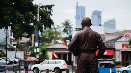 Jakarta, Indonesia - October 2022: The statue of Ismail Marzuki from behind facing the highway that...