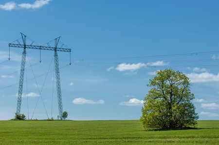 Electric post in a field and blue sky. electric high voltage power post. high voltage post.High-voltage tower sky background. Electricity poles. の写真素材