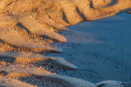  drawing in the sand on the tide. texture. beach sand background. footprints in the sand. 