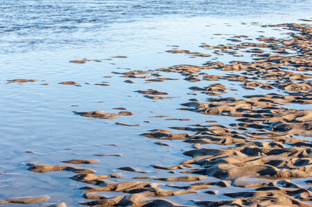  drawing in the sand on the tide. texture. beach sand background. footprints in the sand. の写真素材