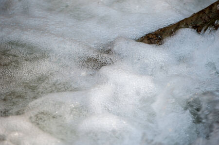 water fall. River on the white background. Stream flowing fast over rocks. Beautiful veil cascading waterfall, mossy rocksの写真素材