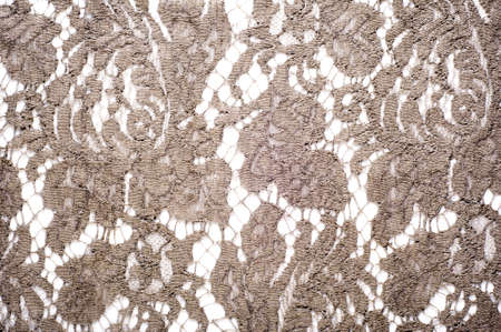 texture lace. a fine open fabric, typically one of cotton or silk, made by looping, twisting, or knitting thread in patterns and used especially for trimming garments.の写真素材