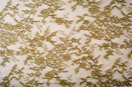 texture lace. a fine open fabric, typically one of cotton or silk, made by looping, twisting, or knitting thread in patterns and used especially for trimming garments.の写真素材