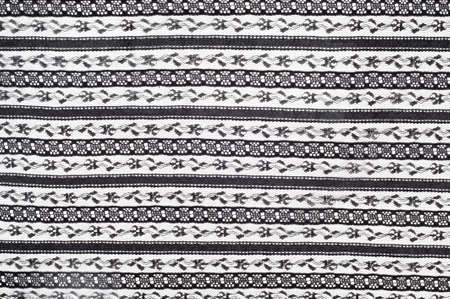 texture lace. a fine open fabric, typically one of cotton or silk, made by looping, twisting, or knitting thread in patterns and used especially for trimming garments.の写真素材