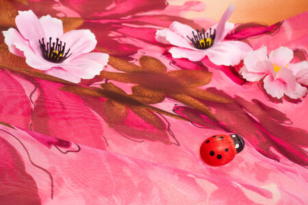Pink fabric inlaid flowers. texture. Photographed in the studioの写真素材
