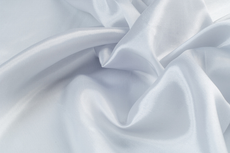 fabric gray white. tissue, textile, cloth, fabric, material, texture. cloth, typically produced by weaving or knitting textile fibers.の写真素材