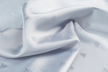 fabric gray white. tissue, textile, cloth, fabric, material, texture. cloth, typically produced by weaving or knitting textile fibers.の写真素材