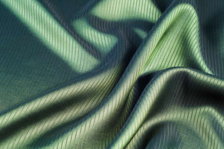 green striped fabric. texture. of the color between blue and yellow in the spectrum; colored like grass or emeralds.の写真素材