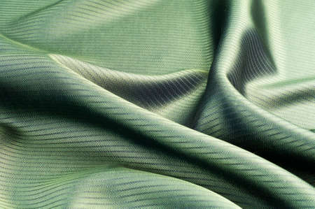 green striped fabric. texture. of the color between blue and yellow in the spectrum; colored like grass or emeralds.の写真素材