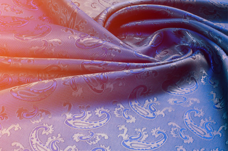 The texture of the silk fabric. Dark blue. With a picture of cucumbers. a fine, strong, soft,...