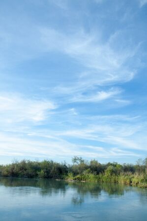 Steppe river reeds summer. views in the view of the river. small blue river by a sunny dayの写真素材