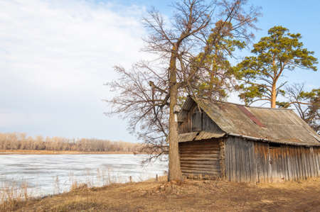Spring River, the ice on the river. picturesque spring landscape with river ice melted bare trees and beautiful clouds in the blue skyの写真素材