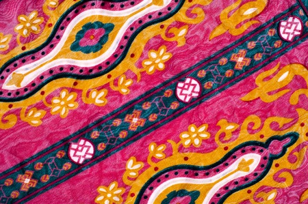 Texture silk cloth with a red pattern. The red cloth with Welsh pears is photographed close-up. Indian floral pattern with cucumbers on a natural silk cloth.の写真素材