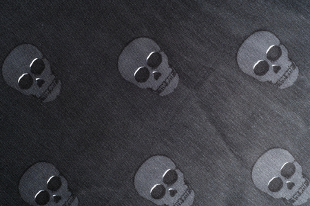 The texture of the silk fabric in black with small skulls pirateの写真素材