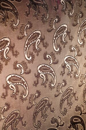 Fabric silk texture color Sandy Brown. With woven into the fabric flowers