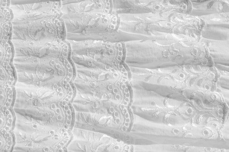 White cotton fabric, with patterns.  tissue, textile, cloth, material, texture