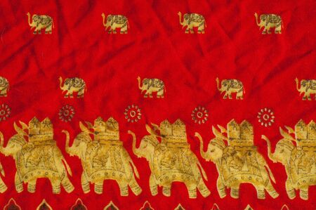 The texture of cotton fabric, with red painted elephants, made in Indiaの写真素材