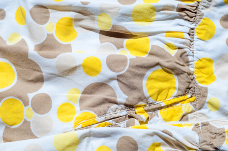 The texture of the fabric jersey with a white circle painted yellow brownの写真素材