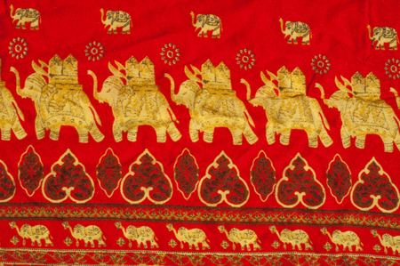 The texture of cotton fabric, with red painted elephants, made in Indiaの写真素材