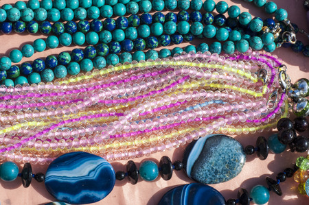 bead, chaplet, beading. a small piece of glass, stone, or similar material, typically rounded and perforated for threading with others as a necklaceの写真素材