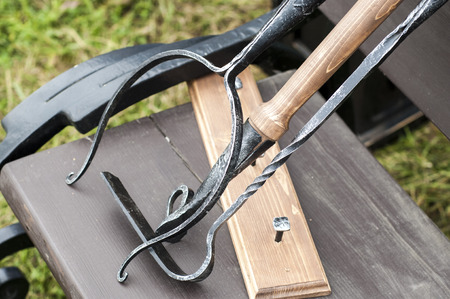 A blacksmith is a metalsmith who creates objects from wrought iron or steel by forging the metal, using tools to hammer, bend, and cut (cf. whitesmith)の写真素材