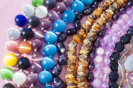 bead, chaplet, beading. a small piece of glass, stone, or similar material, typically rounded and perforated for threading with others as a necklaceの写真素材