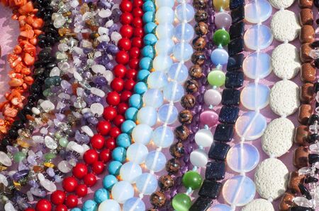 bead, chaplet, beading. a small piece of glass, stone, or similar material, typically rounded and perforated for threading with others as a necklaceの写真素材