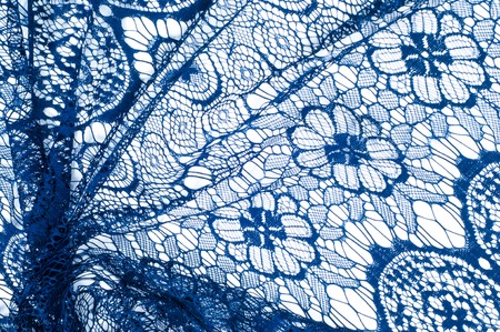 Texture lace fabric. lace on white background studio. thin fabric made of yarn or thread. typically one of cotton or silk, made by looping, twisting, or knitting thread in patternsの写真素材