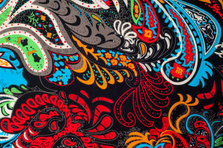 fabric, texture, background, silk fabric, black red yellow green blue white coloring. Flowersの写真素材