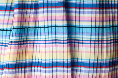 Pleated fabric. Sinii yellow red white stripes texture. Photography Studioの写真素材