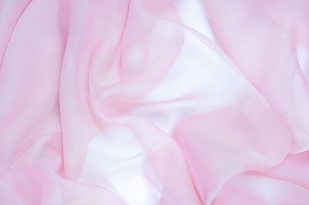 The texture of the silk fabric, soft pink.  rose-color, rose-colour, rose. Beautiful soft crumpled pink silk textureの写真素材