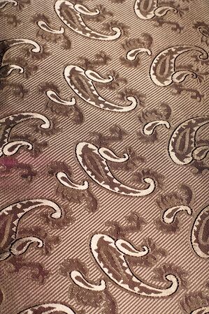 Fabric silk texture color Sandy Brown. With woven into the fabric flowers