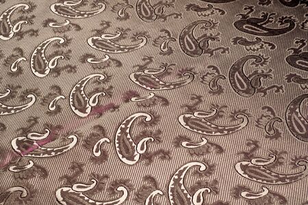 Fabric silk texture color Sandy Brown. With woven into the fabric flowers