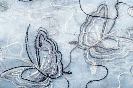 Texture, background. Tulle, organza. Beautiful patterns with butterflies