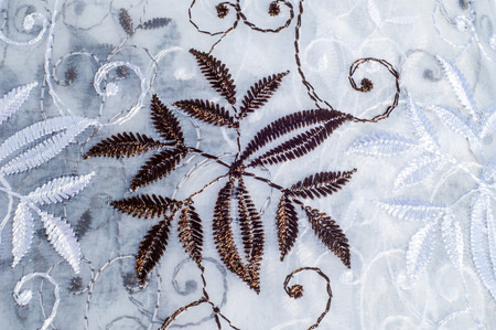 Tulle, organza, white, with a pattern of flowers. a thin, stiff, transparent fabric made of silk or...