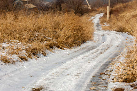 Country road and fields on the background of the blue. Country road through the fields. Road lane and deep blue sky. Nature design.の写真素材