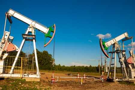 oil pump. Oil industry equipment. filtered picture of oil pump jack. Oil and gas industry. Work of oil pump jack on a oil field.の写真素材