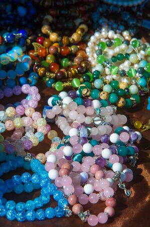female beads. a small piece of glass, stone, or similar material, typically rounded and perforated...