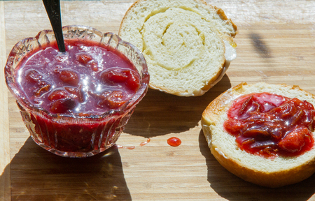 breakfast with jam from plums. Muffin smeared plum jam.の写真素材