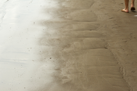 Texture, background. the sand on the beach. loose granular substance, pale yellowish brown, resulting from the erosion of siliceous and other rocks and forming a major constituent of beaches,の写真素材